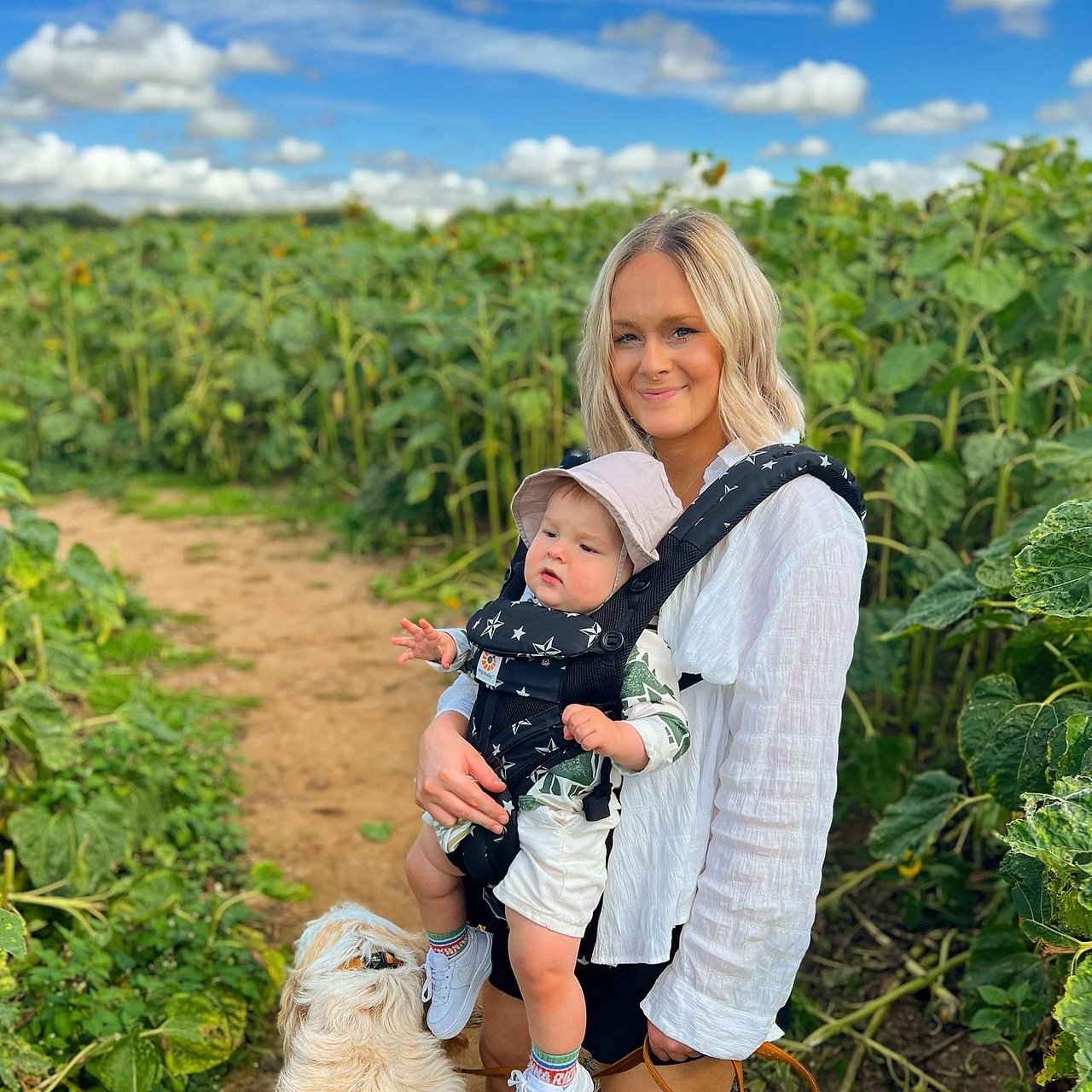 Baillie and Freddie stood in a field of sunflowers