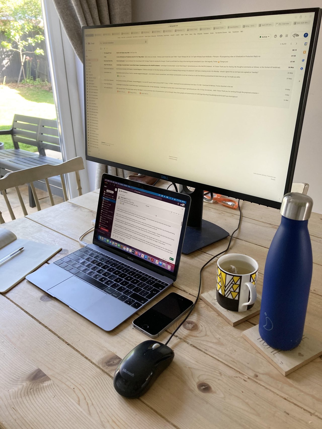 An image of a desk with a monitor and laptop.